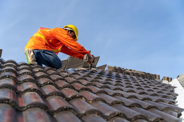 bigstock-A-Roofer-Working-On-Roof-Struc-455939139