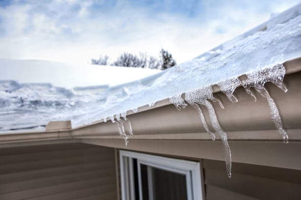 bigstock-Ice-dam-in-gutter-and-ice-froz-403932143