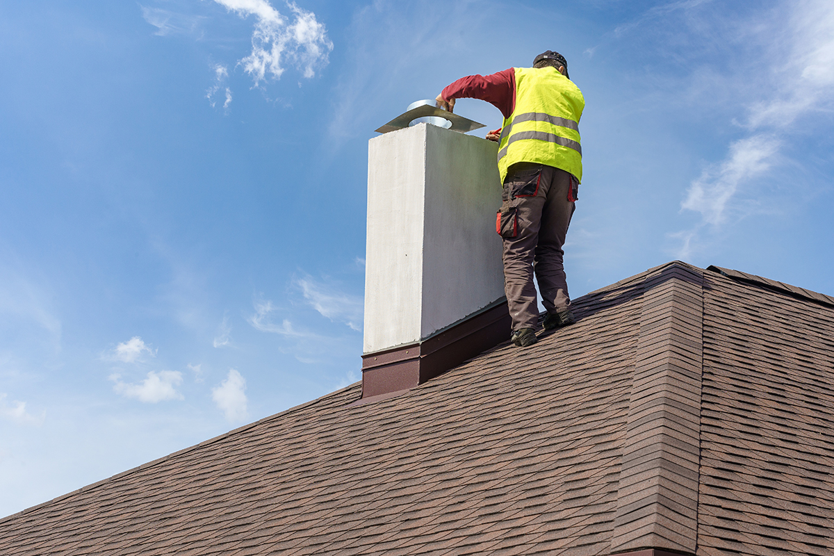 Man Performing Chimney & Roof Inspection